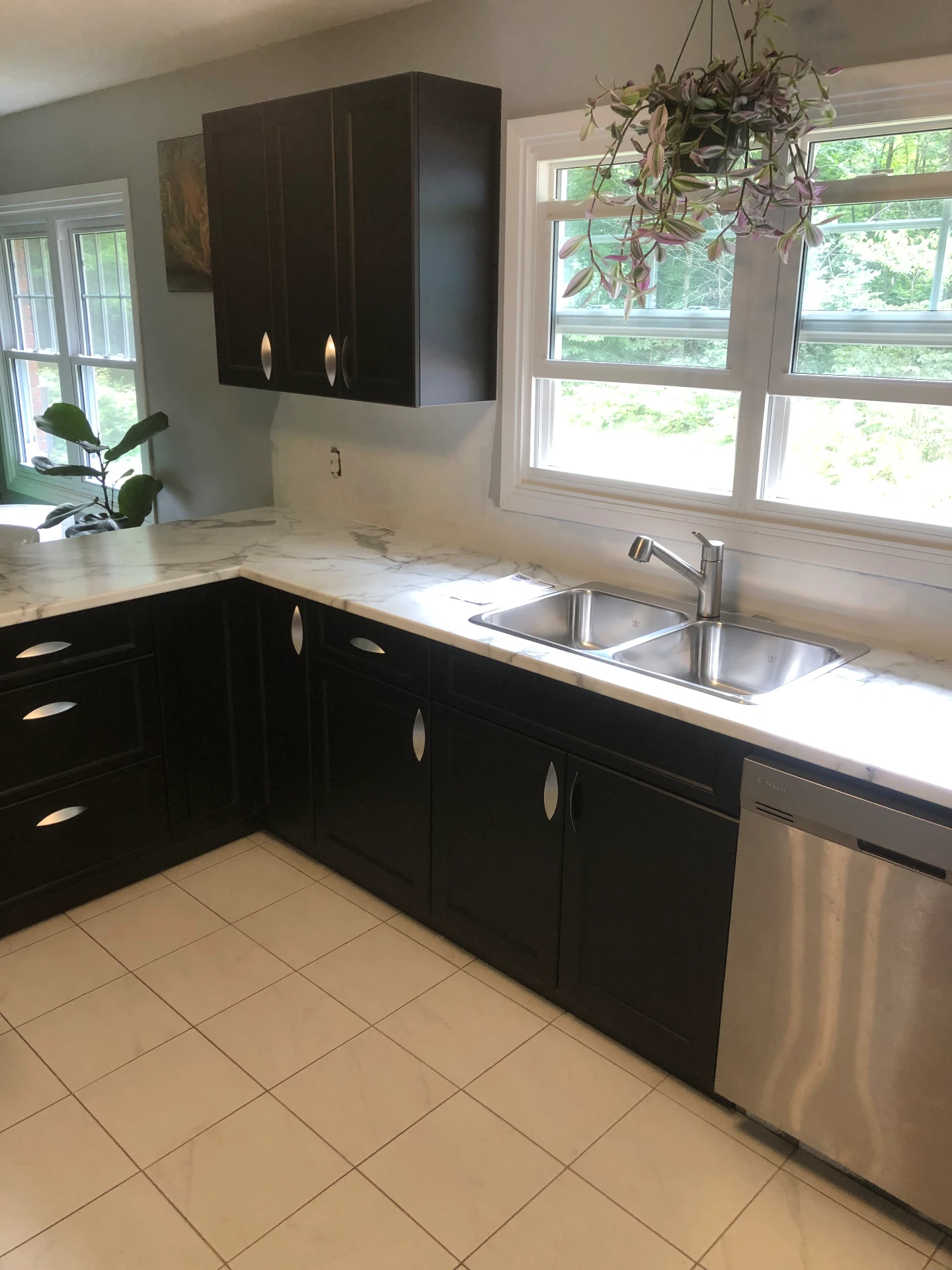 Dark custom cabinetry with high-end laminate tops and stainless sink