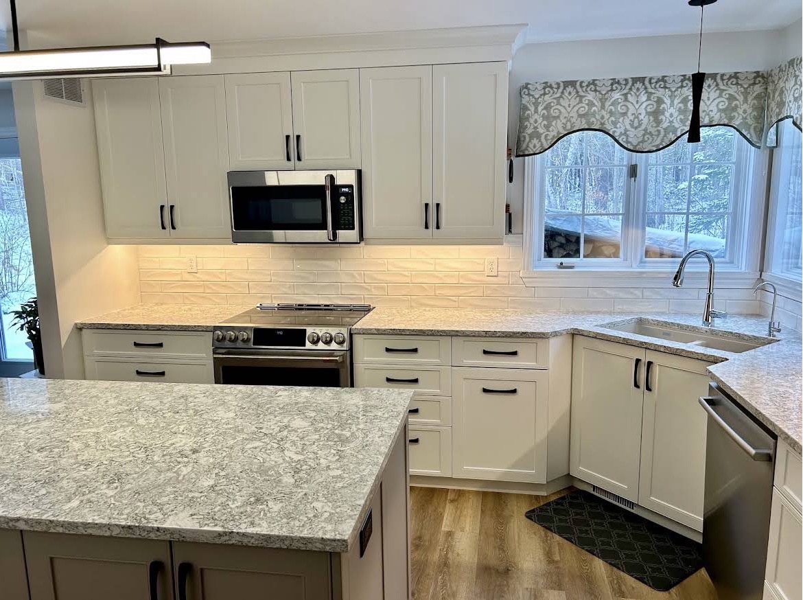 White shaker custom cabinetry with matte black hardware and subway tile backsplash